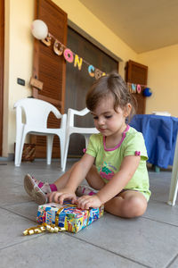 Girl playing with toy at home during birthday