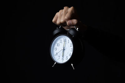 Close-up of human hand against black background