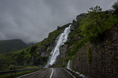 Scenic view of road amidst mountains against sky