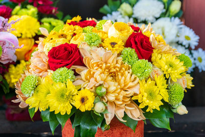 Midsection of woman holding flowers