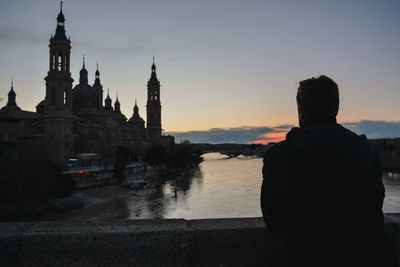 Reflection of buildings in city at sunset