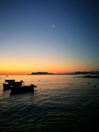 Scenic view of sea against clear sky at sunset