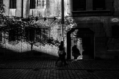 People walking on street amidst buildings