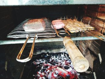 High angle view of meat on barbecue grill