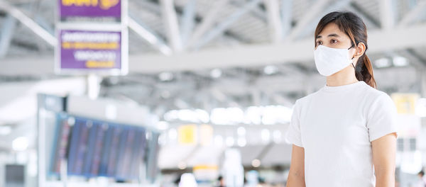 Beautiful woman with mask in airport