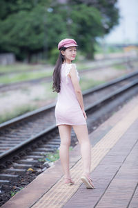 Portrait of woman standing on railroad station platform