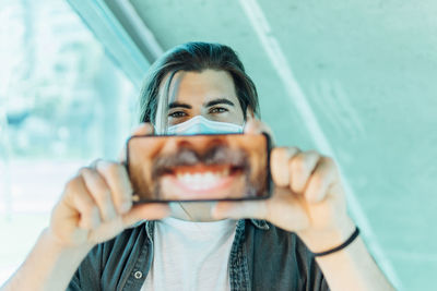 Portrait of man photographing camera