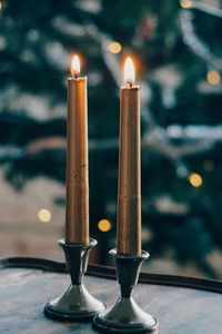 Close-up of illuminated candles on table