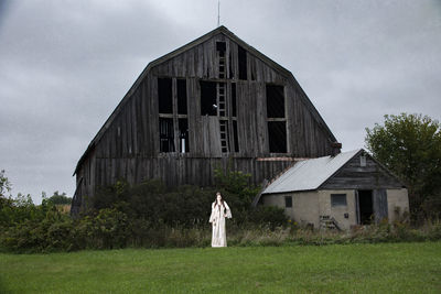 Abandoned house on field against sky