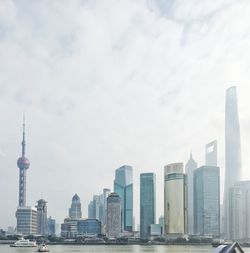 View of skyscrapers against cloudy sky