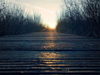 Close-up of road against sky at sunset