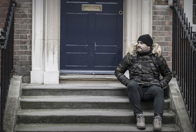 Full length of man sitting on steps