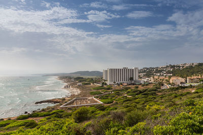 Scenic view of sea and buildings against sky