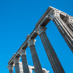 Low angle view of historic building against blue sky