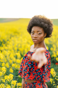 Beautiful woman standing on field