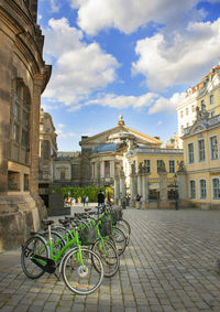 Bicycles on street against buildings in city