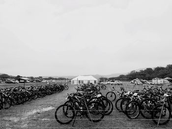 Bicycles parked in row against sky