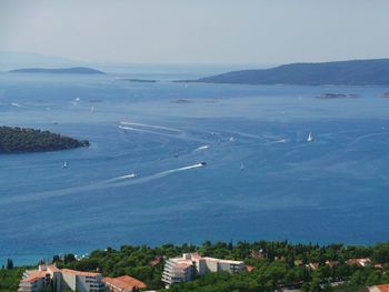 Scenic view of sea and town against clear sky