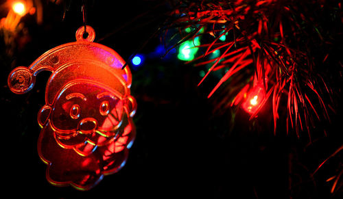 Low angle view of illuminated lanterns hanging at night