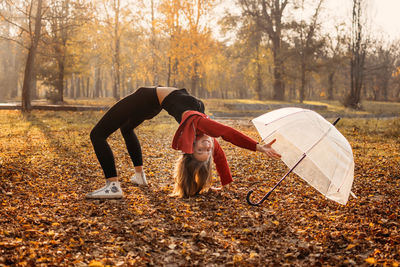 Hello fall, autumn season, fall mood, positive emotions. teenager girl jumping with transparent