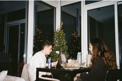 Woman sitting at restaurant table at night