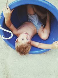 High angle view portrait of boy playing in bowl