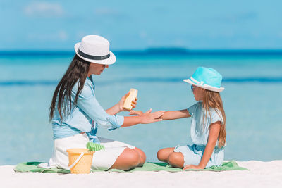 Rear view of woman wearing hat at beach