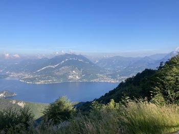 Scenic view of mountains against blue sky