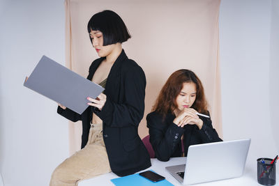 Lesbian couple working in office