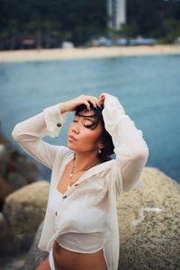 Young woman standing at beach