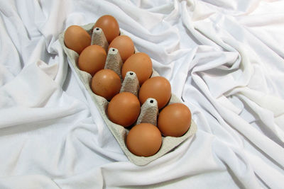 High angle view of eggs on bed