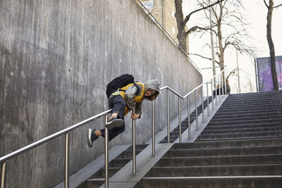 Girl sliding on railing