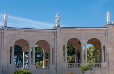 Low angle view of historical building against blue sky