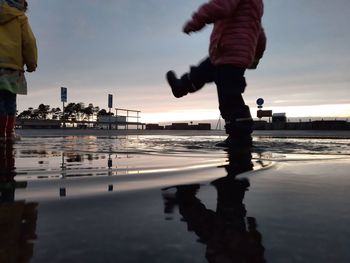 My kids walking through a puddle