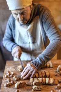 Woman cutting bread on board