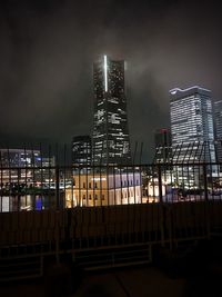 Low angle view of city lit up at night