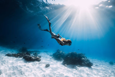 Low angle view of woman swimming in sea