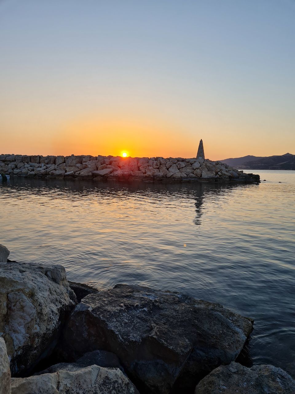 SCENIC VIEW OF SEA AGAINST ORANGE SKY