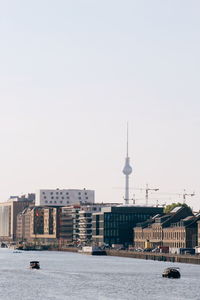 Buildings in city against clear sky