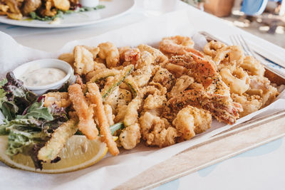 Large plate of fried seafood on a table, selective focus.