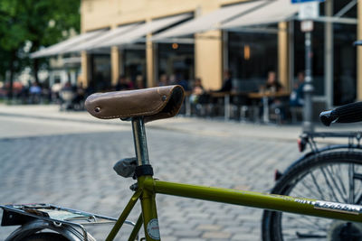 Close-up of bicycle parked on street