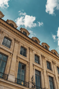 Low angle view of building against cloudy sky