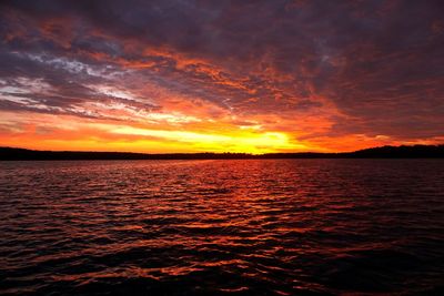 Scenic view of sea against romantic sky at sunset