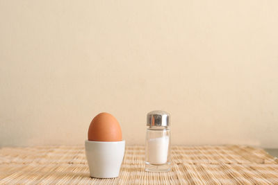Close-up of breakfast on table against wall