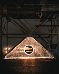 Illuminated wire wool under built structure at night