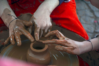 Cropped image of people molding shape in work shop