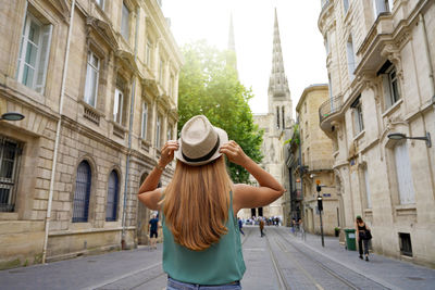 Tourism in france. back view of traveler girl visiting the city of bordeaux, france.