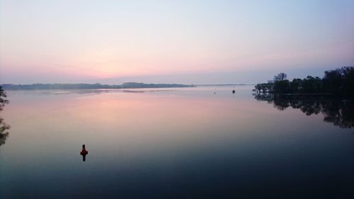 Scenic view of calm lake at sunset