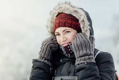 Close-up of smiling woman wearing warm clothing