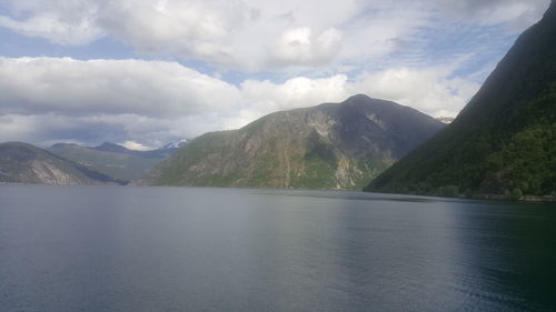 Scenic view of lake and mountains against sky